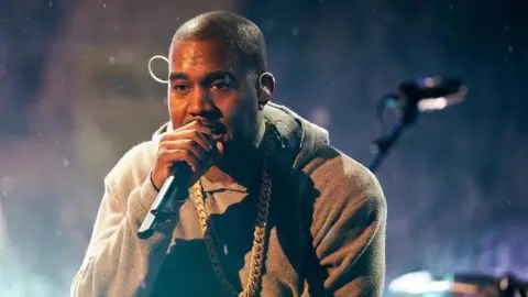 Reuters Kanye West performs with U2 during a surprise concert in support of World AIDS Day in Times Square in New York